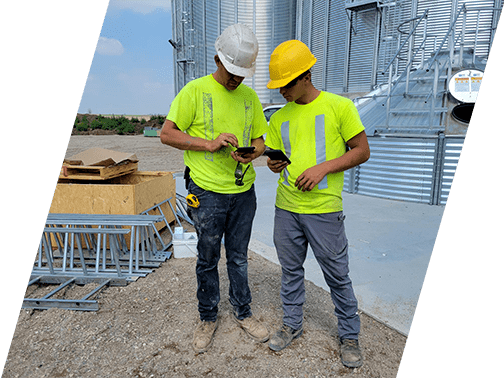 Horst Systems workers reviewing project plans on-site